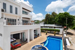 A modern two-story building with a swimming pool, outdoor seating, and a covered patio area. - Sky Pool Villa (Rawai)