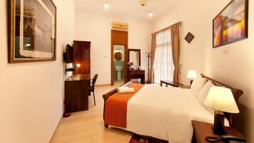 Relax in a stylishly designed room with a comfortable bed, desk, and flat-screen TV.