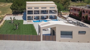 A modern hotel with a pool, multiple floors, and a sign for 'Mystique'.