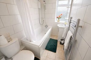 Combined shower/tub, hair dryer, towels, soap