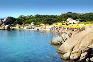 Playa privada, sillas reclinables de playa, sombrillas