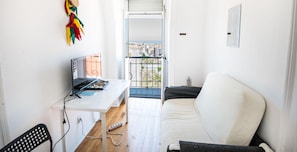 Enjoy a home office setup with a desk and sofa, plus a balcony with city views.