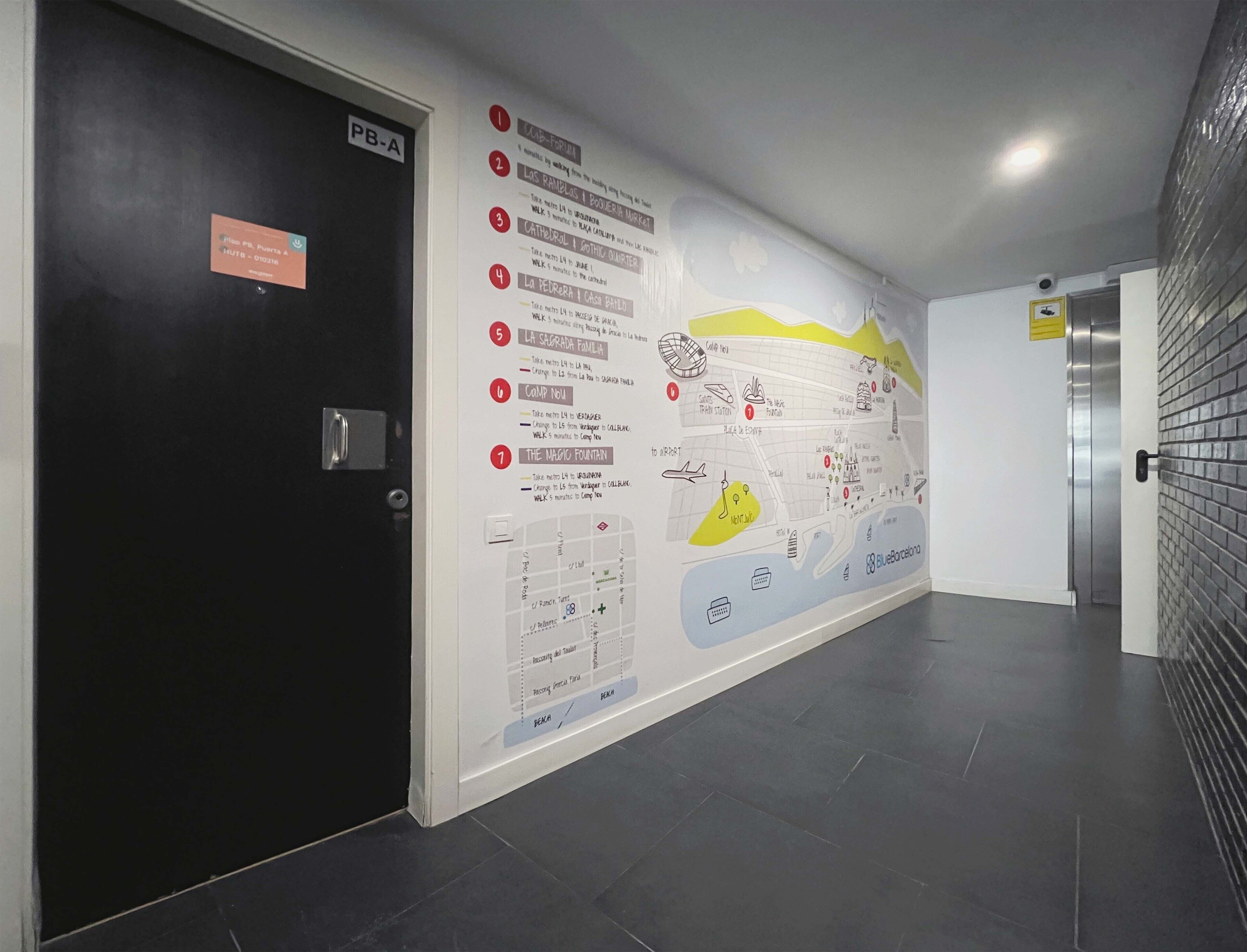 Un couloir avec une carte murale indiquant les directions pour se rendre à différents points d’intérêt et une porte portant l’inscription « PB-A ».