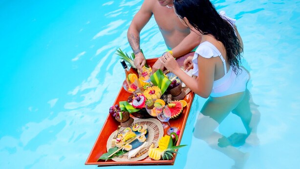 A poolside setting with a tray of food and drinks. - Nature Paradise Cottage • Lovers' Stay (Le Diamant)