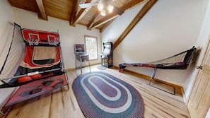 A room with a basketball hoop, a ping pong table, and a hammock. - Dogwood Acre 3 Bedroom Cabin by RedAwning (Sevierville)