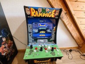 A vintage arcade machine with a green base and a screen displaying multiple game options. - Dogwood Acre 3 Bedroom Cabin by RedAwning (Sevierville)