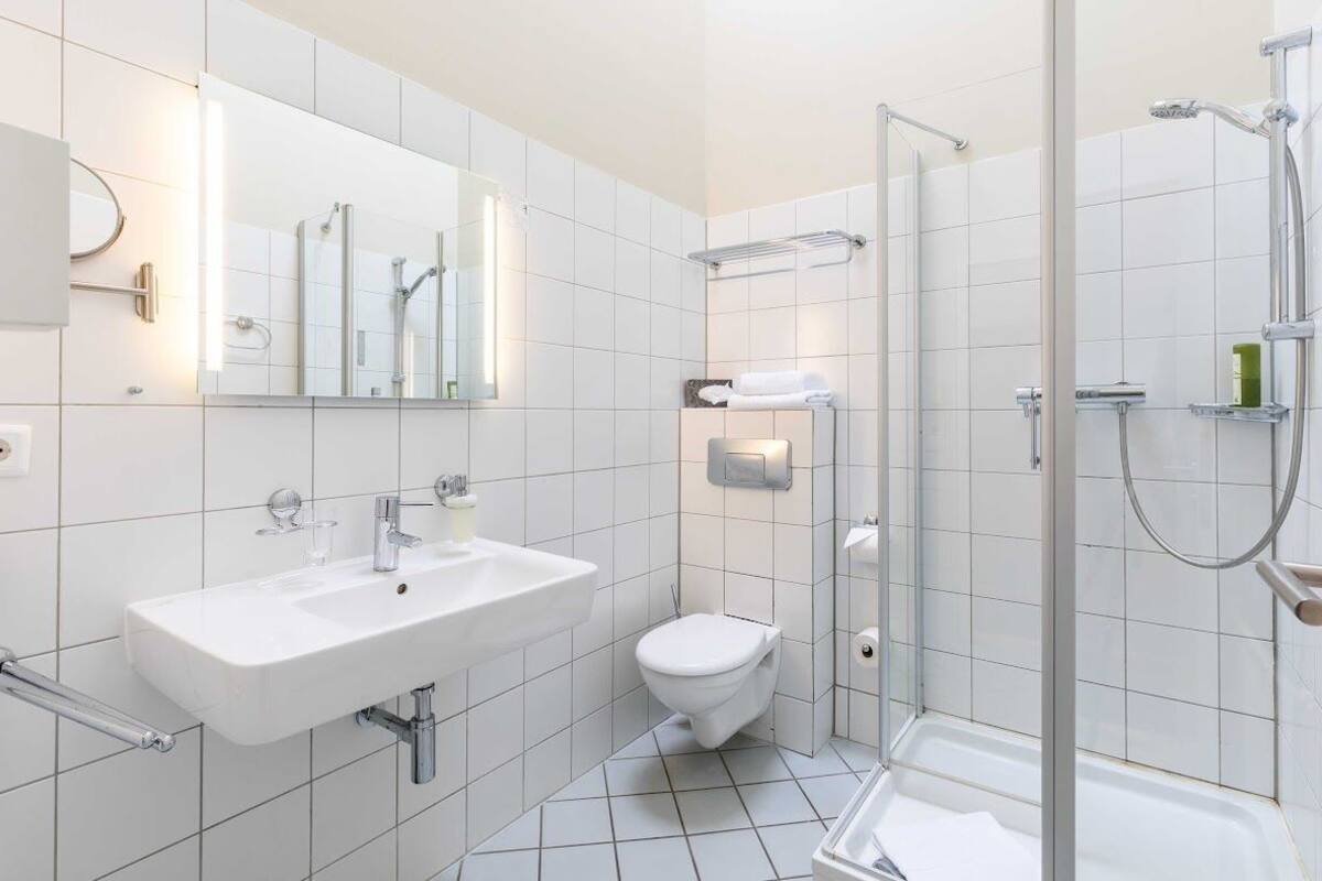 shower, hair dryer, towels, toilet paper