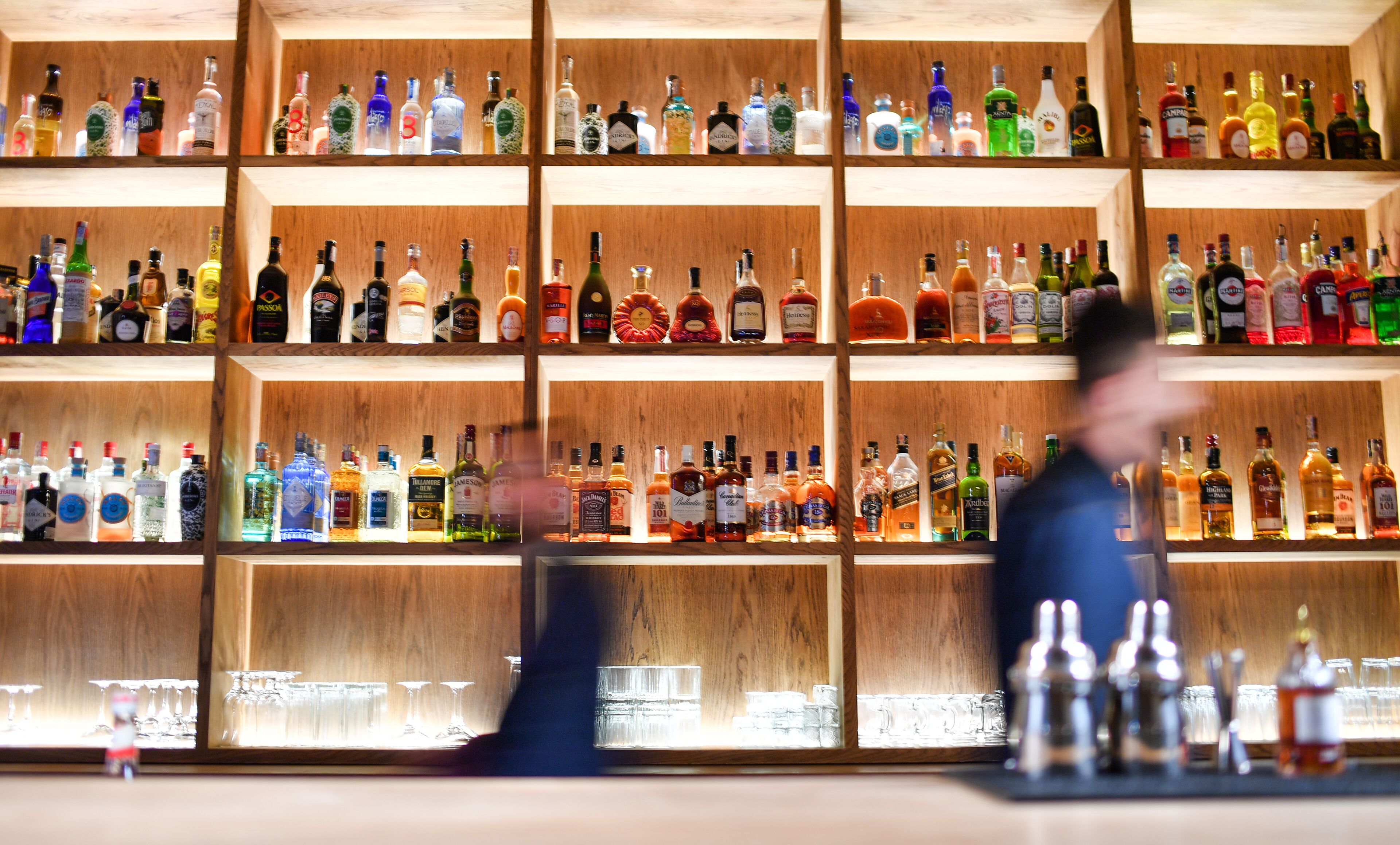 A bar with shelves of various liquor bottles.