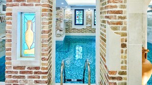 A pool area with a clear view of the water, surrounded by brick walls and a glass window. - Stara Čaršija Hotel and Spa (Bar)