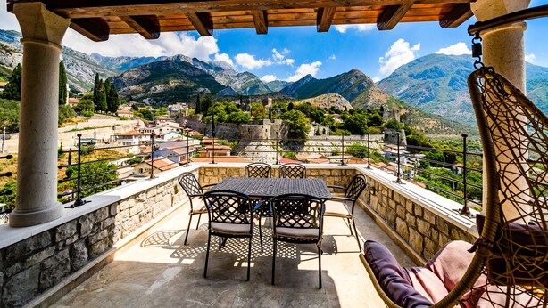 A terrace with a table and chairs, overlooking a mountainous landscape. - Stara Čaršija Hotel and Spa (Bar)