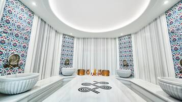 A luxurious bathroom with two large sinks, a central decorative tile with a symbol, and a patterned wall.