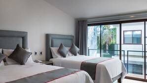 A hotel room with two beds, a balcony with a glass railing, and a view of greenery outside. - Fraga Hotel Boutique (Irapuato)
