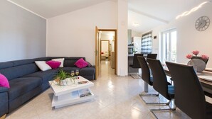 A modern living room with a sofa, coffee table, and dining area. - A comfortable home perfect for relaxing in the green heart of Istria (Bokordici)