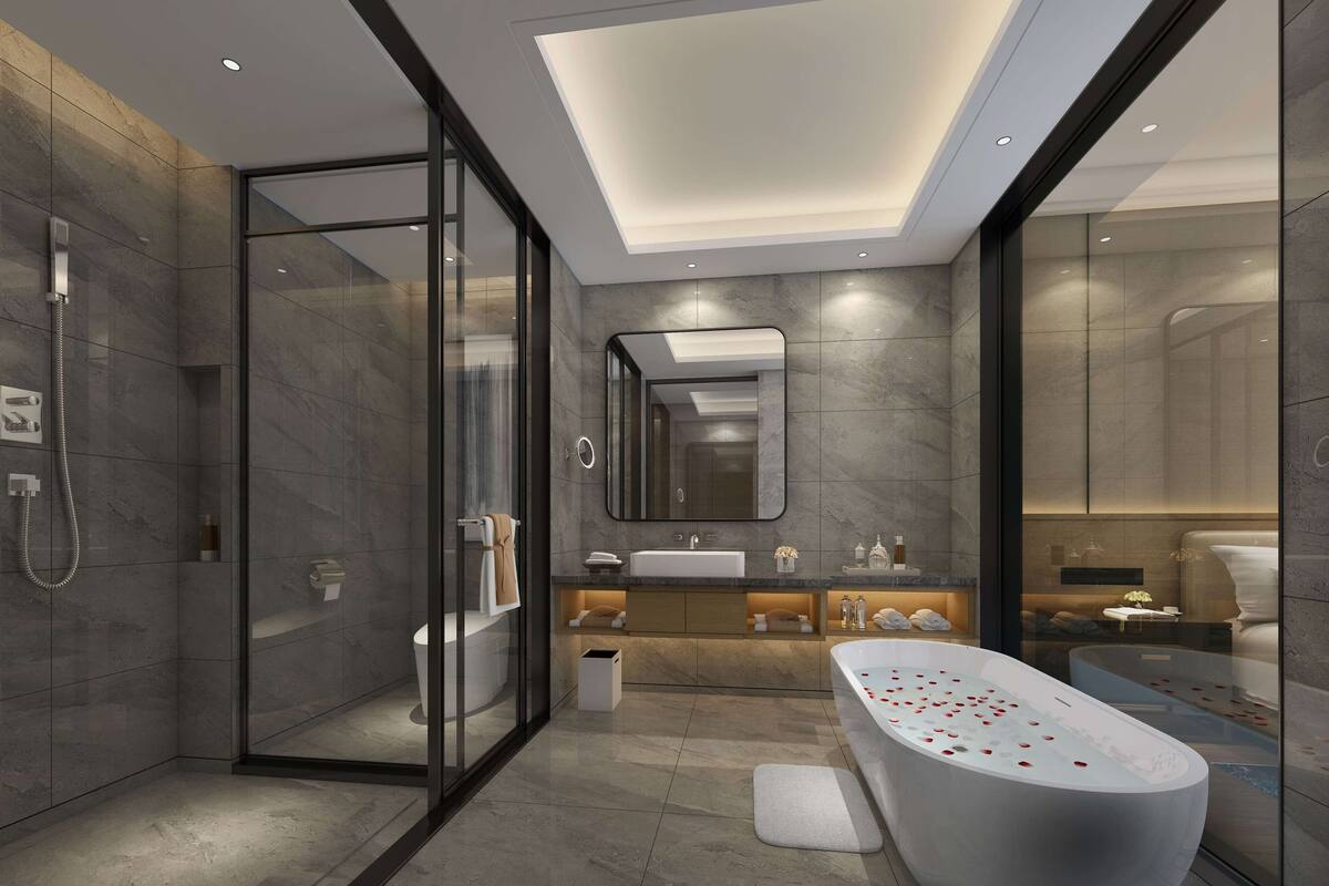 A modern bathroom with a glass-enclosed shower, a freestanding bathtub, and a vanity with a mirror.