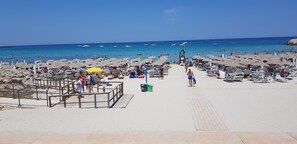 On the beach, sun-loungers