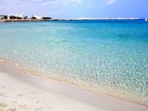 On the beach, sun-loungers