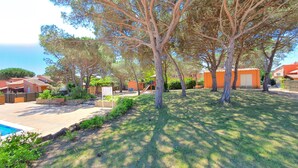 A residential area with a swimming pool, a playground, and houses with orange roofs. - Pinell Mar House rental in Estartit near the beach (Torroella de Montgri)