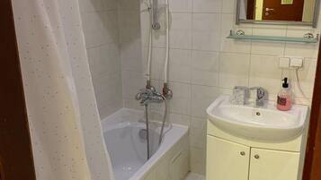 Apartamento | Banheiro | Chuveiro/banheira combinados, secador de cabelo, chinelos