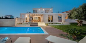 A modern two-story house with a swimming pool, outdoor seating, and a well-maintained garden. - Luxury Villa Cinderella with Swimming Pool (Primosten)