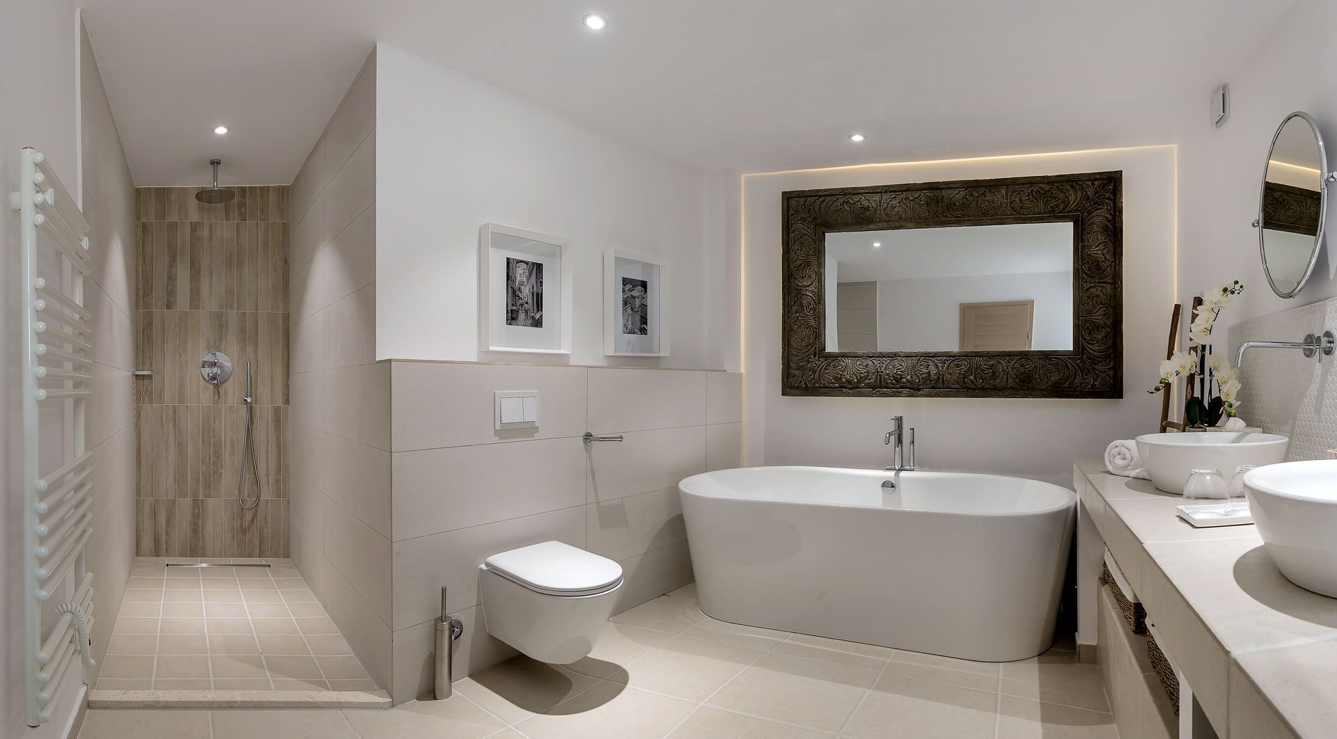 A modern bathroom with a freestanding bathtub, a toilet, and a shower area.
