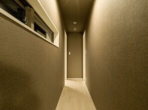 Stylish hallway with a door leading to a space.