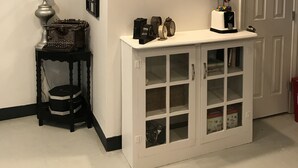 A hallway with a white console table, a black side table with a lamp, and a door with a white frame. - Urban Chic Studio, Private, 1B1B.  Belhaven area.   Near campus& hospitals. (Jackson)