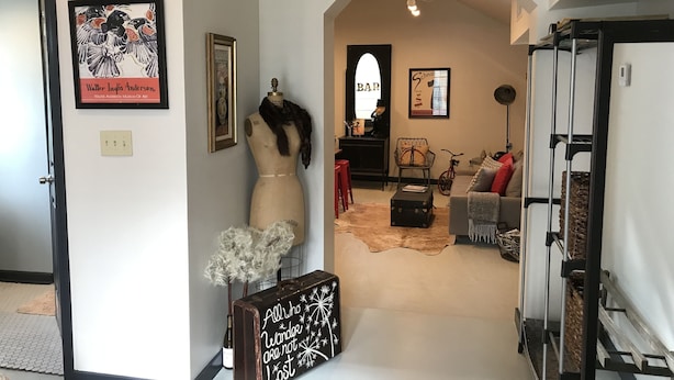 A living room with a mannequin, a bar area, and a staircase. - Urban Chic Studio, Private, 1B1B.  Belhaven area.   Near campus& hospitals. (Jackson)