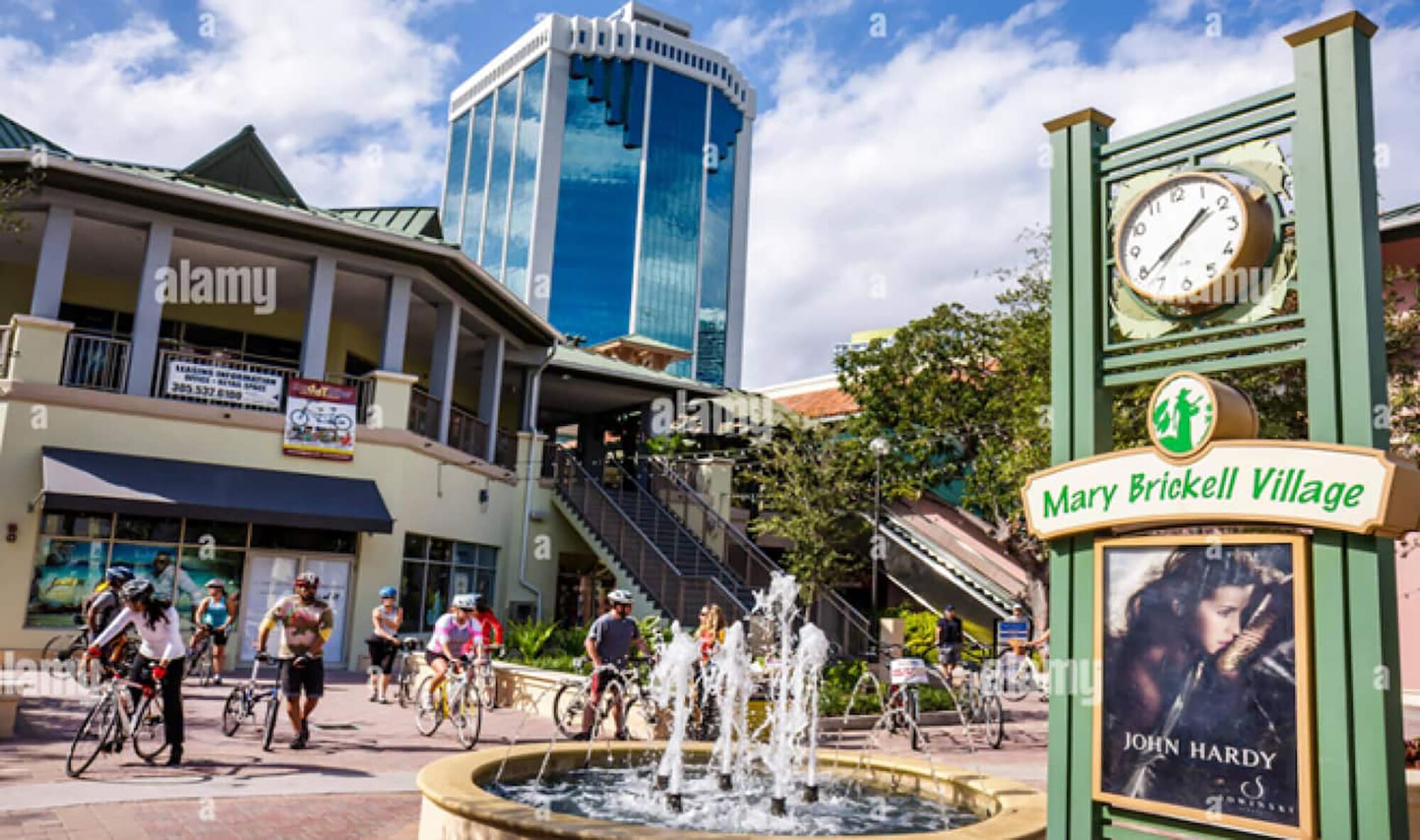 A public square with a clock, a fountain, and a sign for Mary Brickell Village.