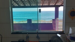 A bathroom with a large window overlooking the ocean, a sink, and a towel rack. - You in Paradise in Arraial do Cabo, amazing house facing the beach. Do not miss it !! (Arraial do Cabo)
