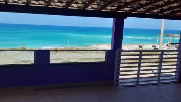 A covered outdoor area with a view of the ocean. - You in Paradise in Arraial do Cabo, amazing house facing the beach. Do not miss it !! (Arraial do Cabo)