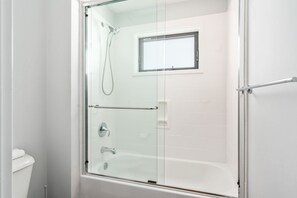 Combined shower/bathtub, hair dryer, towels, soap