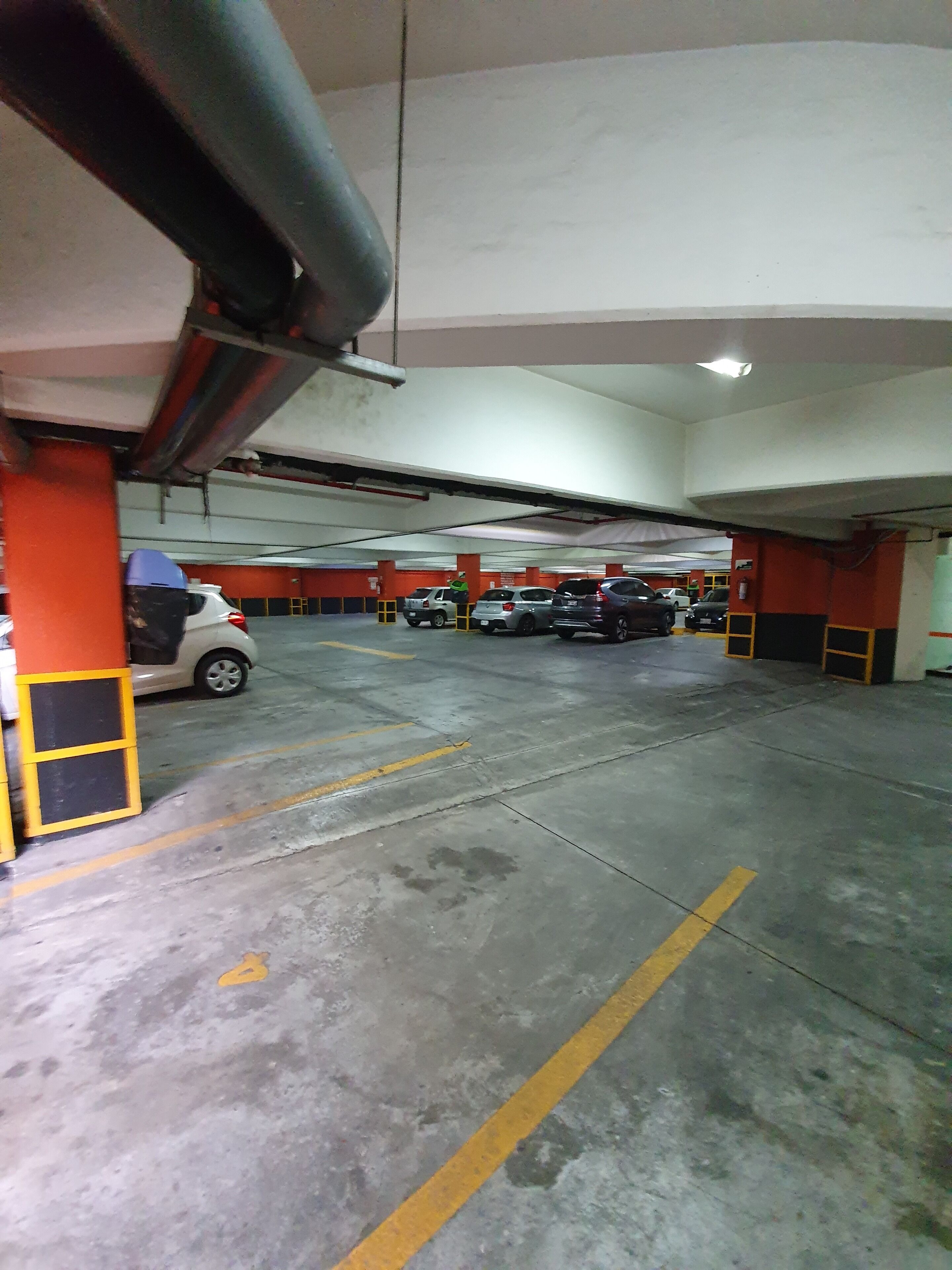 Un aparcamiento de varios niveles con varios coches estacionados.
