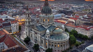 A historic building with a prominent dome and bell tower, surrounded by a cityscape with various buildings and streets. - Pullman Budapest (Budapest)