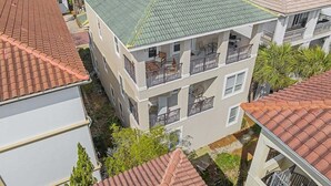 A multi-story residential building with balconies and a green roof. - Private Beach | Gulf Views | Comm Pool | Elevator (Destin)