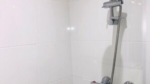 A shower with a handheld showerhead and a wall-mounted control panel. - Townhouse @ Corporation Street Stoke (Stoke-on-Trent)