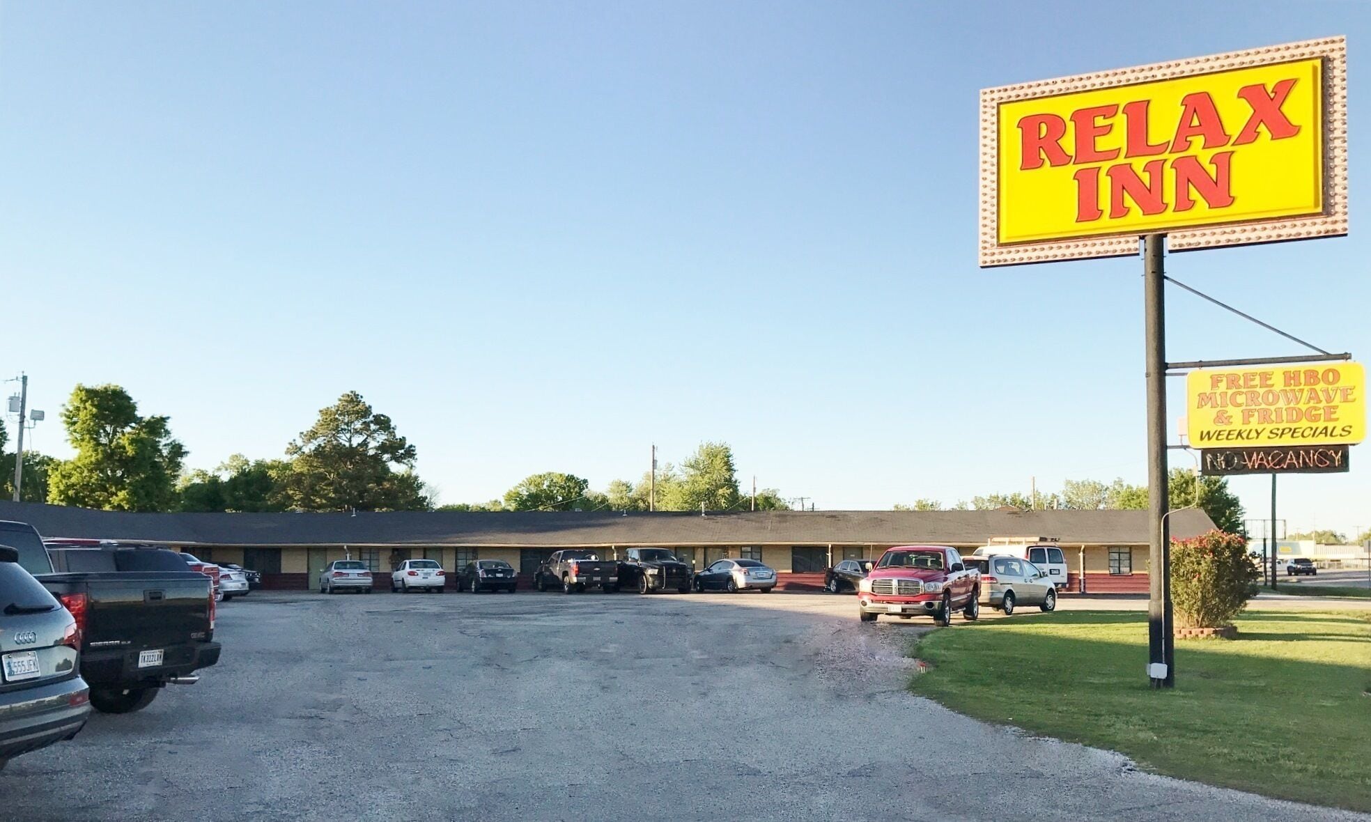 A parking lot with a building labeled "Relax Inn."