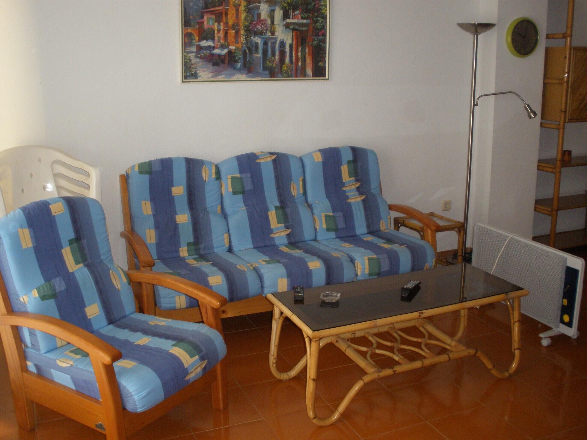 Un salon comprenant un canapé, une table basse et un lampadaire.
