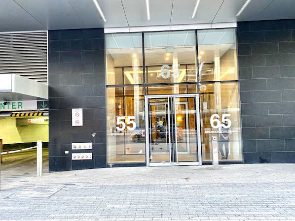 Welcome to the entrance of this building, featuring a revolving door and address numbers 55 and 65.