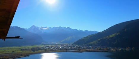 A mountainous landscape with a lake and a town in the valley.