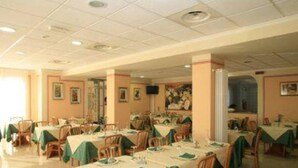 A dining area with tables set for meals, chairs, and a ceiling with recessed lighting. - Hotel Villa Ada (Borgio Verezzi)