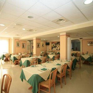 A dining area with tables set for meals, chairs, and a ceiling with recessed lighting. - Hotel Villa Ada (Borgio Verezzi)
