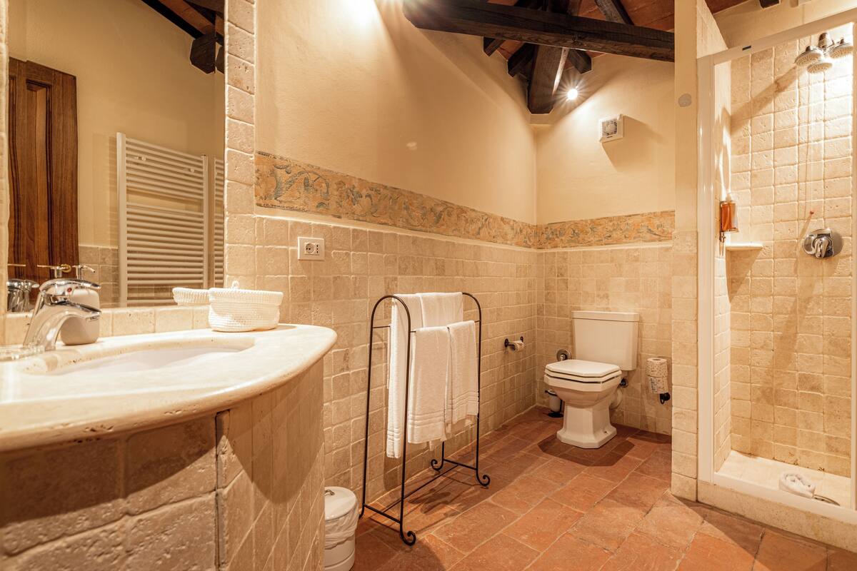 A bathroom with a sink, toilet, and shower.