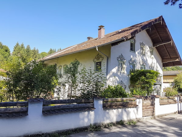 Un bâtiment à deux étages, doté d’un toit recouvert de tuiles et de cadres de fenêtres décoratifs.