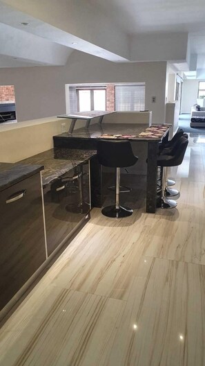 Enjoy cooking in this well-equipped kitchen with a central island, sink, and oven.