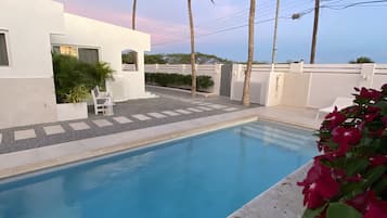 Outdoor pool, open 9:00 AM to 9:00 PM, pool loungers