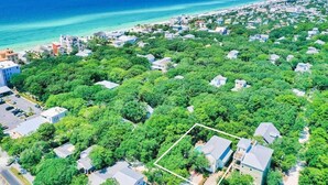 An aerial view of a residential area with houses surrounded by dense greenery, a beach, and the ocean in the background. - Luxury Old Seagrove, BeachComer, Walk to Beach and Seaside, 3 King BRs, Private Heated Pool (Seagrove Beach)