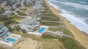 A coastal residential area with houses, a beach, and a swimming pool. - Serendipity - Oceanfront, Duck, 5 BR, 4.5BA, Private Pool & Hot Tub (Duck)