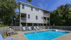 A rectangular swimming pool with a wooden deck and lounge chairs. - Luzon - 5 BR, 4.5 BA, Oceanside home in Duck w/Private Pool (Duck)
