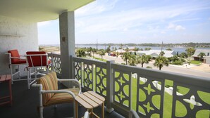 A balcony with a view of a beach and a body of water. There are chairs and a table on the balcony. - El Matador 544 - FREE TICKETS!! Your stay includes free tickets to many area attractions! (Fort Walton Beach)