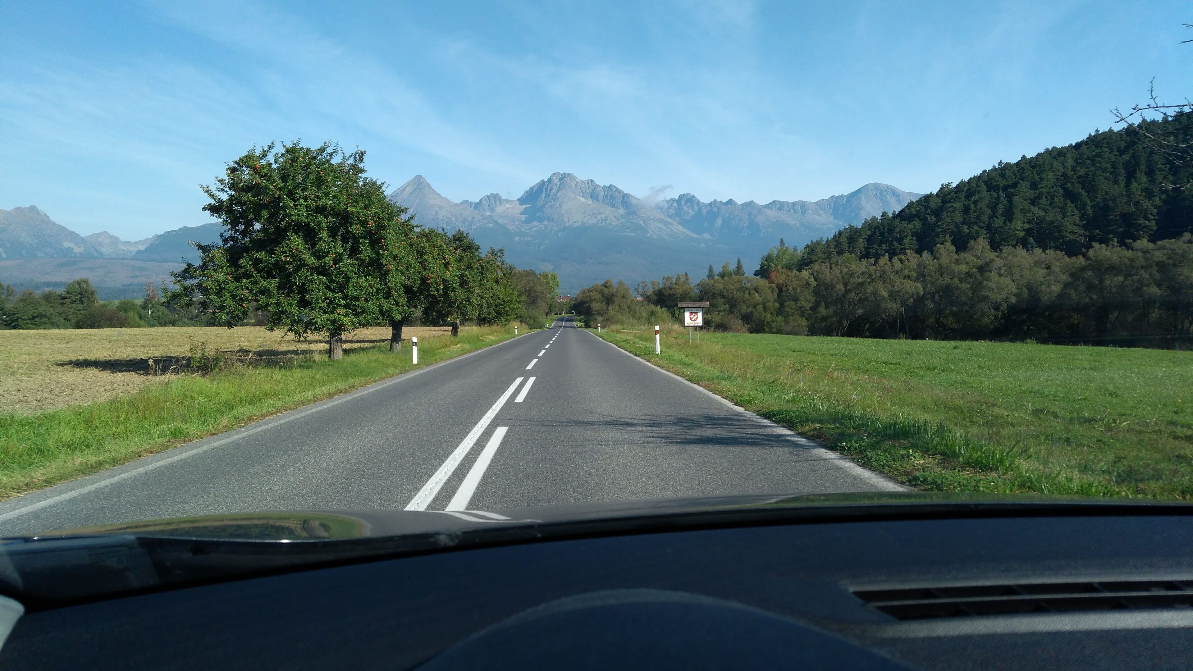 A road with a clear view of mountains in the distance.